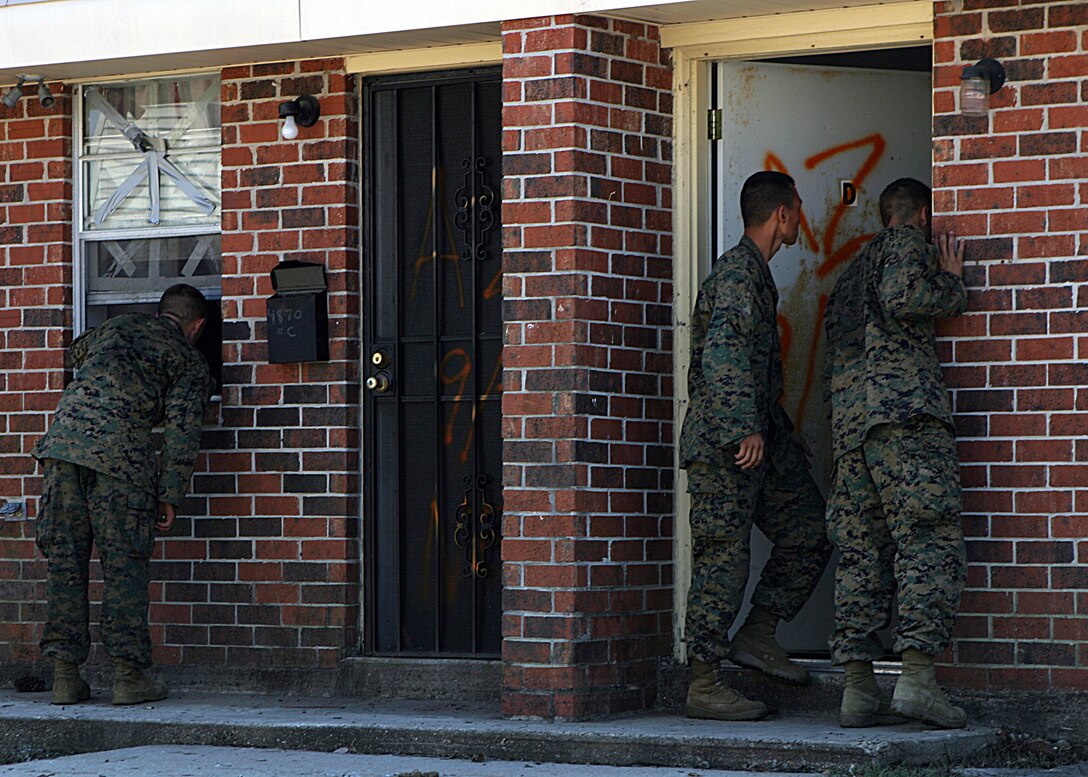 NEW ORLEANS (Sep. 8, 2005) - Infantrymen from Bravo Company, 1st Battalion, 8th Marines, conduct door to door searches in an effort to rescue those stranded by Hurricane Katrina. The infantrymen disembarked from amphibious assault vehicles in the few dry sections of Orleans and St. Bernard Parishes to conduct search and rescue. In areas submerged in flood water, AAVs from 4th Amphibious Assault Battalion, a reserve unit headquartered in Jacksonville, Fla., maneuvered to second story windows and doors to look for survivors.