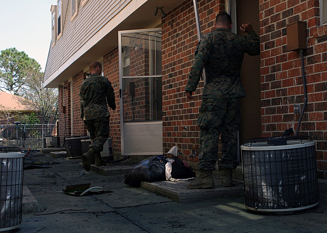 NEW ORLEANS (Sep. 8, 2005) - Infantrymen from Bravo Company, 1st Battalion, 8th Marines, conduct door to door searches in an effort to rescue those stranded by Hurricane Katrina. The infantrymen disembarked from amphibious assault vehicles in the few dry sections of Orleans and St. Bernard Parishes to conduct search and rescue. In areas submerged in flood water, AAVs from 4th Amphibious Assault Battalion, a reserve unit headquartered in Jacksonville, Fla., maneuvered to second story windows and doors to look for survivors.
