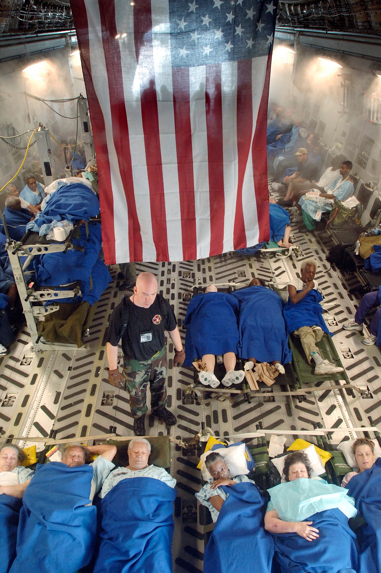 NEW ORLEANS -- Capt. Gary Hardy helps prepare sick and injured people for a flight aboard a C-17 Globemaster III.  They are being evacuated to Dobbins Air Force Base, Ga. Captain Hardy is a flight nurse with the 43rd Aeromedical Evacuation Squadron, at Pope AFB, N.C., The aircraft and flight crew are from the 446th Airlift Wing at McChord AFB, Wash. (U.S. Air Force photo Master Sgt. Lance Cheung)
