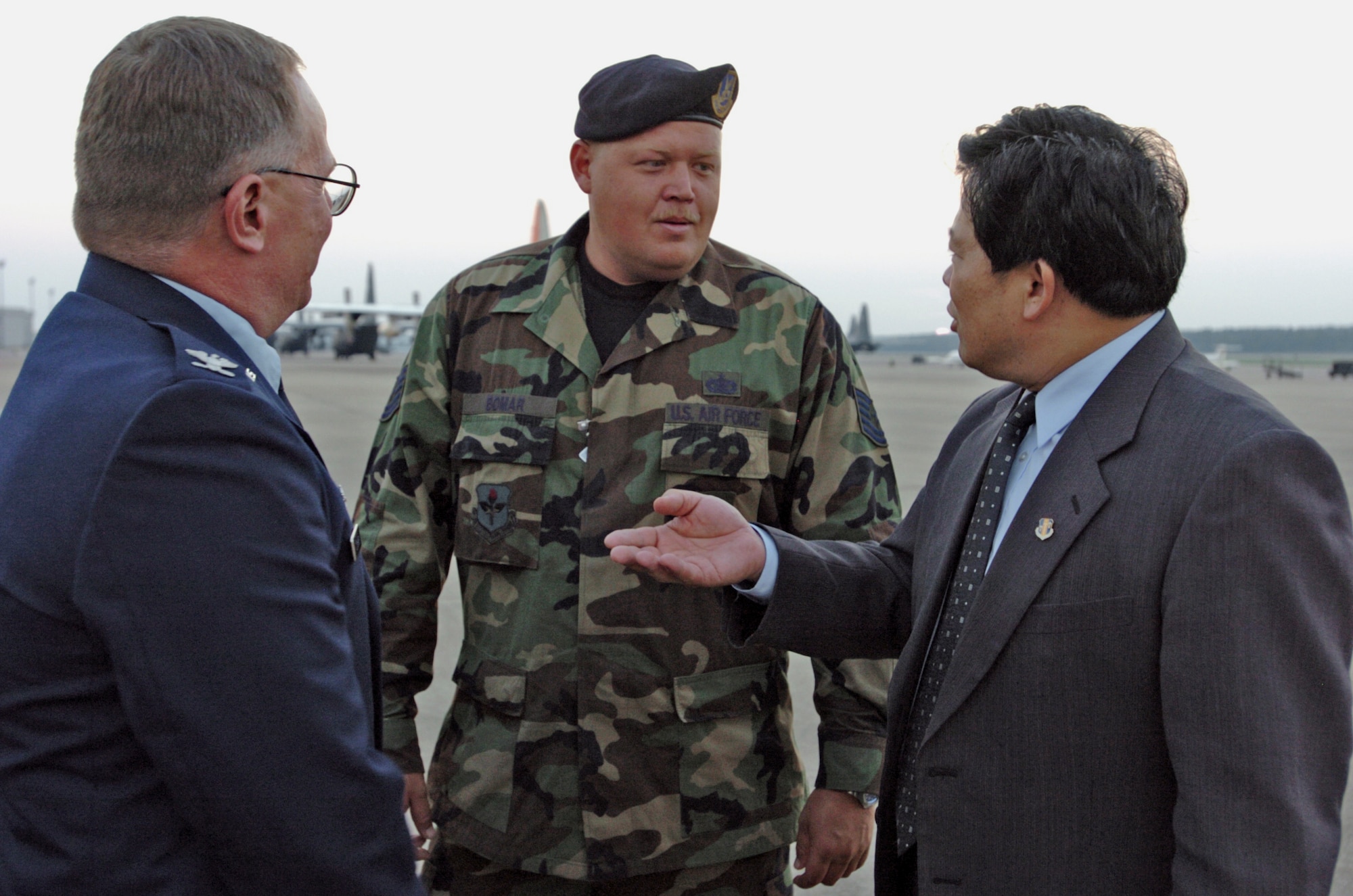 LITTLE ROCK AIR FORCE BASE, Ark. -- Col. Jac Starkey (left) and Tech. Sgt. Daniel Bomar talk with Hu Yeshun after the arrival of a Chinese humanitarian aid shipment for Hurricane Katrina relief operations. It marked the 17th international aid flight to land here since Sept. 5, delivering a combined 934 tons of relief supplies. Colonel Starkey is commander of the 314th Mission Support Group, Sergeant Bomar is the kennel master for the 314th Security Forces Squadron, and Mr. Yeshun is consul general for the People's Republic of China. (U.S. Air Force photo by Tech. Sgt. Christopher Steffen)
