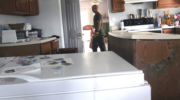 Flooding brought on by storm surge from Hurricane Katrina levied massive devastation on Staff Sgt. Edward J. Schneider's Slidell, La., home, overturning furniture, appliances, and even the island in middle of his kitchen. Schneider was getting help with recovery from Marines from 1st Battalion, 8th Marines. The battalion was in the area to assist with relief efforts in the wake of Hurricane Katrina.