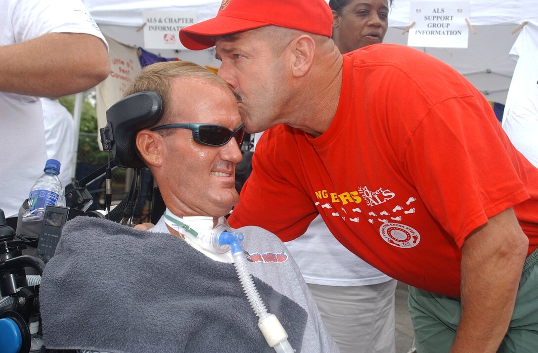 EMERALD ISLE, N.C. - Colonel Richard J. Smith, the assistant chief of staff of Training and Operations for Marine Corps Base, kisses the forehead of retired Maj. Randy L. Herbert before participating in the 2nd Annual Emerald Isle, N.C. - Walk to D'Feet Amyotrophic Lateral Sclerosis Saturday.  Smith and Herbert served together in the Gulf War.