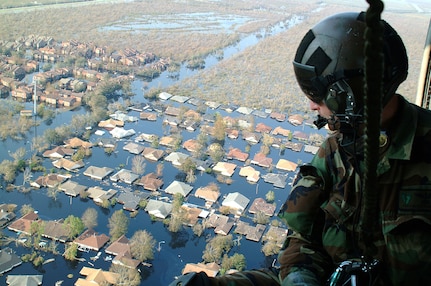 OVER NEW ORLEANS -- Tech. Sgt. Keith Berry looks down into flooded streets searching for survivors.  He is part of an Air Force Reserve team credited with saving more than 1,040 people in the aftermath of Hurricane Katrina.  He is a pararescueman with the 304th Rescue Squadron from Portland, Ore.  (U.S. Air Force photo by Master Sgt. Bill Huntington)
