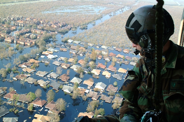 OVER NEW ORLEANS -- Tech. Sgt. Keith Berry looks down into flooded streets searching for survivors.  He is part of an Air Force Reserve team credited with saving more than 1,040 people in the aftermath of Hurricane Katrina.  He is a pararescueman with the 304th Rescue Squadron from Portland, Ore.  (U.S. Air Force photo by Master Sgt. Bill Huntington)