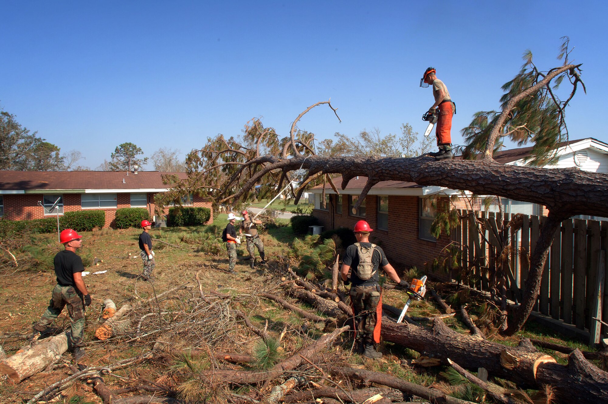 KEESLER AIR FORCE BASE, Miss. -- Airmen with the 823rd Red Horse Squadron from Hurlburt Field, Fla., start another day of clearing and removing fallen trees from the base housing area here.  More than 90 of the squadron's Airmen are deployed here to help with the base's hurricane recovery effort.  (U.S. Air Force photo by Master Sgt. Efrain Gonzalez)