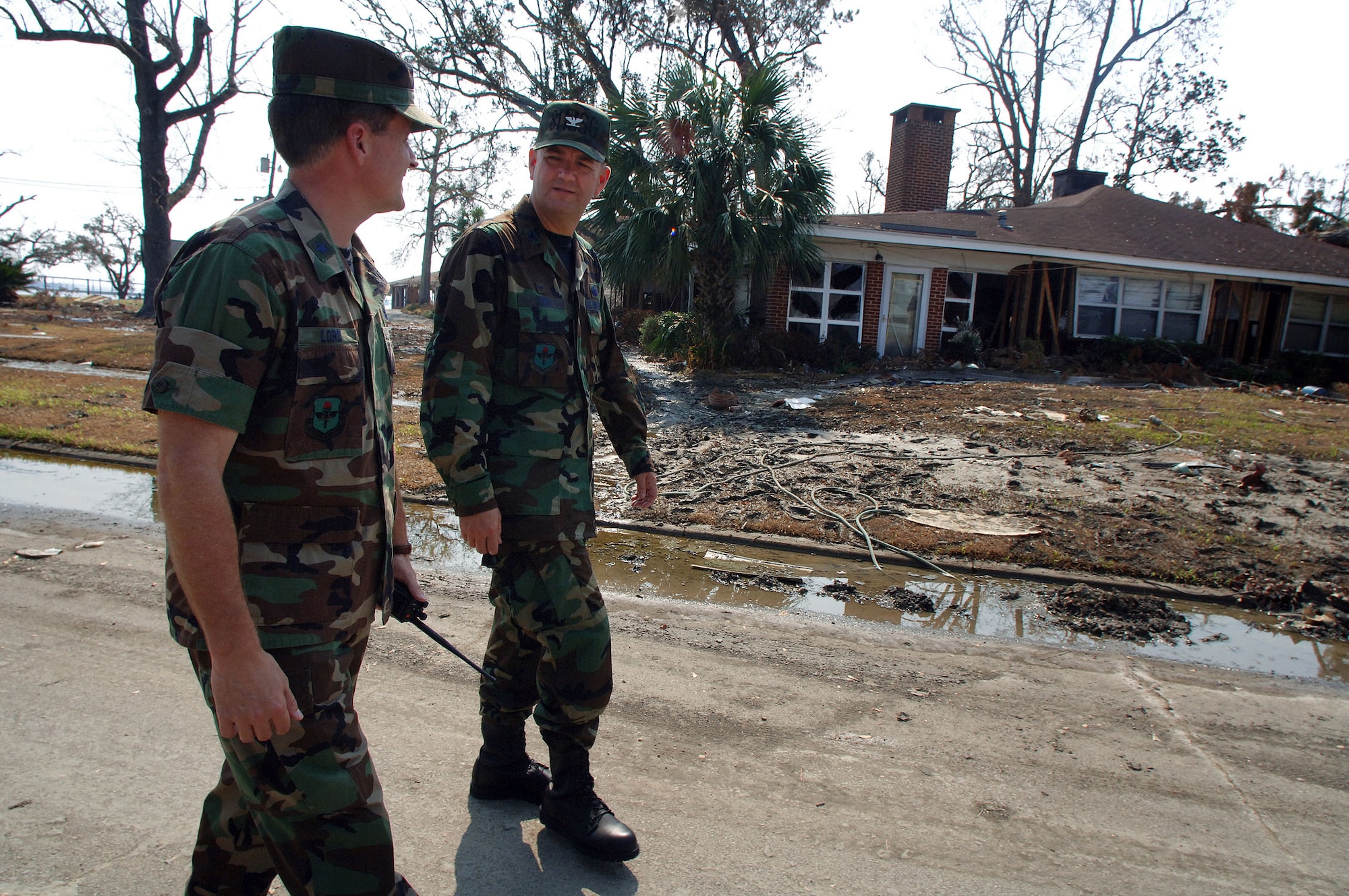KEESLER AIR FORCE BASE, Miss. -- Brig. Gen. William T. Lord (left) walks with Col. Bruce Bush in a housing area here that was hit by Hurricane Katrina.  General Lord is the 81st Training Wing commander, and Colonel Bush is the 81st Mission Support Group commander.  (U.S. Air Force photo by Master Sgt. Efrain Gonzalez)