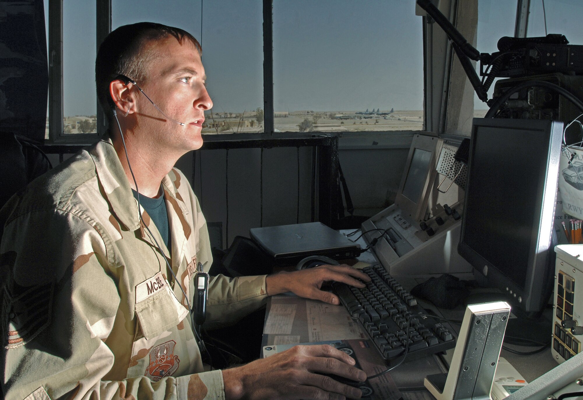 ALI BASE, Iraq -- Tech. Sgt. Chad McBee checks local weather to relay to a pilot. Sergeant McBee is a tower controller with the 407th Expeditionary Operations Support Squadron and is deployed from Pope Air Force Base, N.C. (U.S. Air Force photo by Master Sgt. Maurice Hessel)
