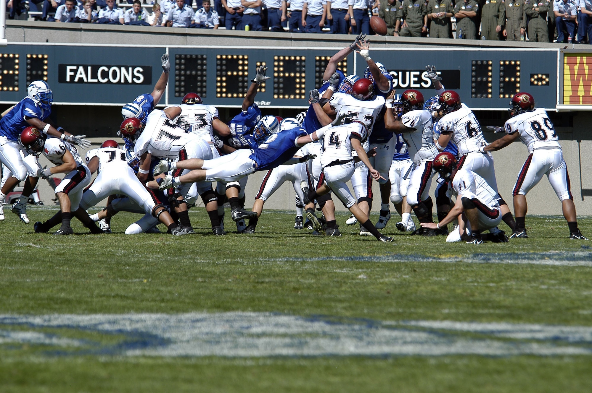 U.S. AIR FORCE ACADEMY, Colo. -- Falcon special teams member Carson Bird, 2, gets horizontal trying to block a field goal attempt by San Diego State University place kicker Garrett Palmer, 14.  The kick was good.  The Falcons went on to beat the Aztecs 41-29.  (U.S. Air Force photo by 2nd Lt. John Ross)