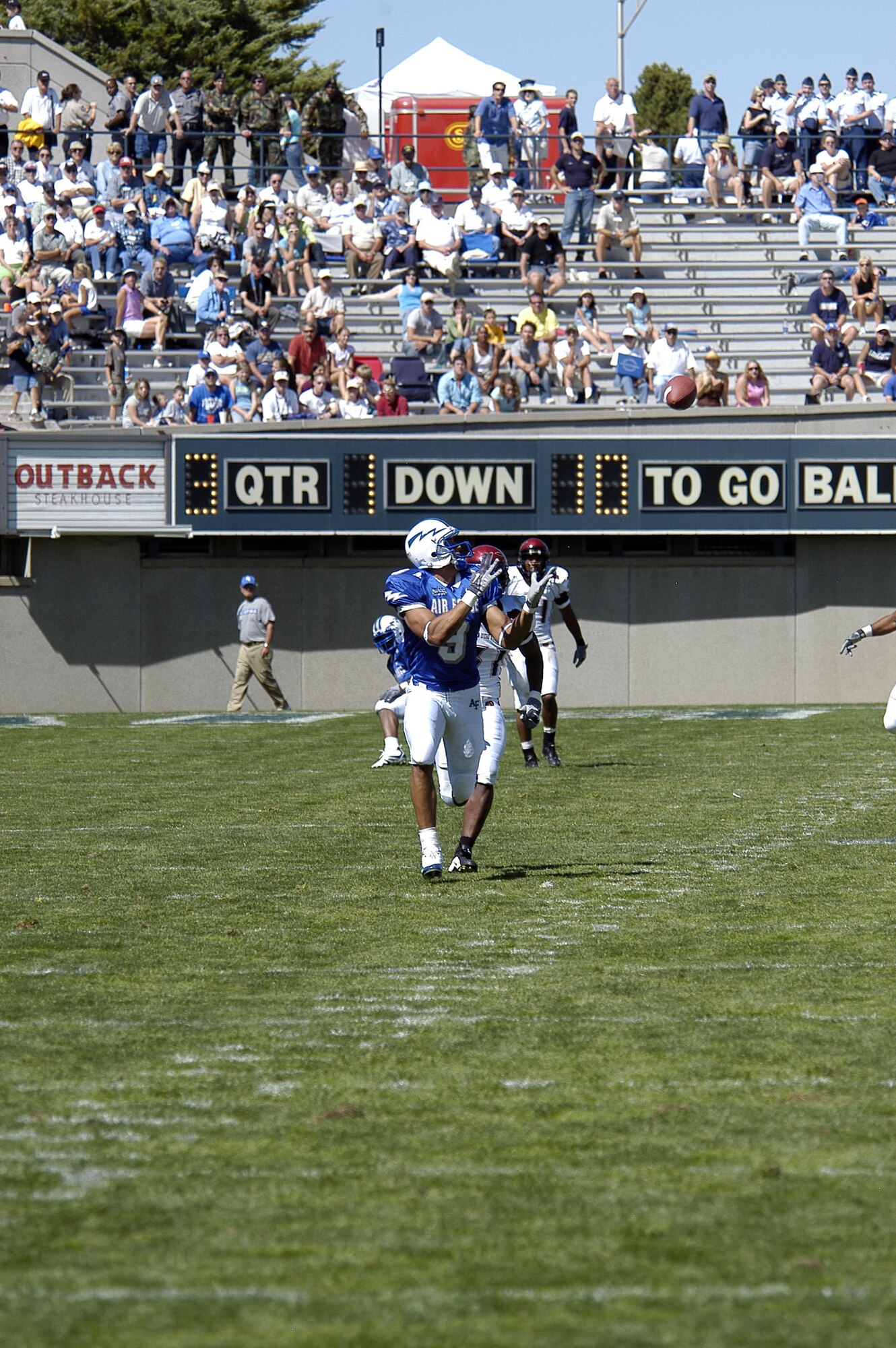 U.S. AIR FORCE ACADEMY, Colo. -- Falcon wide receiver Jason Brown settles under a pass from quarterback Shaun Carney after getting past a San Diego State University defensive back.  The play, the longest of the game, went for a 61-yard completion before Brown fumbled out of bounds.  The Falcons beat the Aztecs 41-29.  (U.S. Air Force photo by 2nd Lt. John Ross)