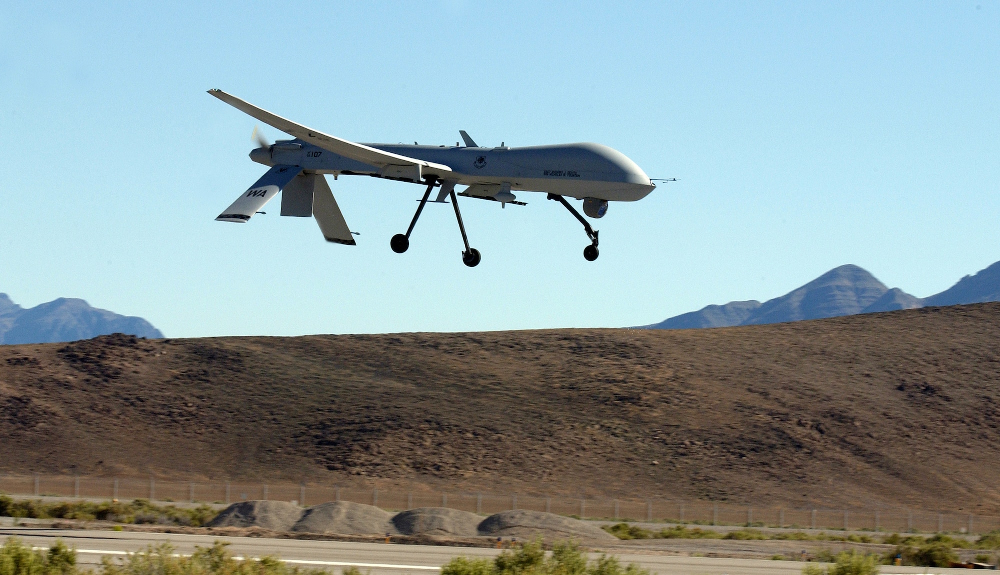OVER NEVADA -- An MQ-1 Predator makes its final approach to Indian Springs Auxiliary Field.  The Predator has flown more than 27,000 hours supporting operations Enduring Freedom and Iraqi Freedom from June 2004 to June 2005.  (U.S. Air Force photo by Tech. Sgt. Kevin J. Gruenwald)