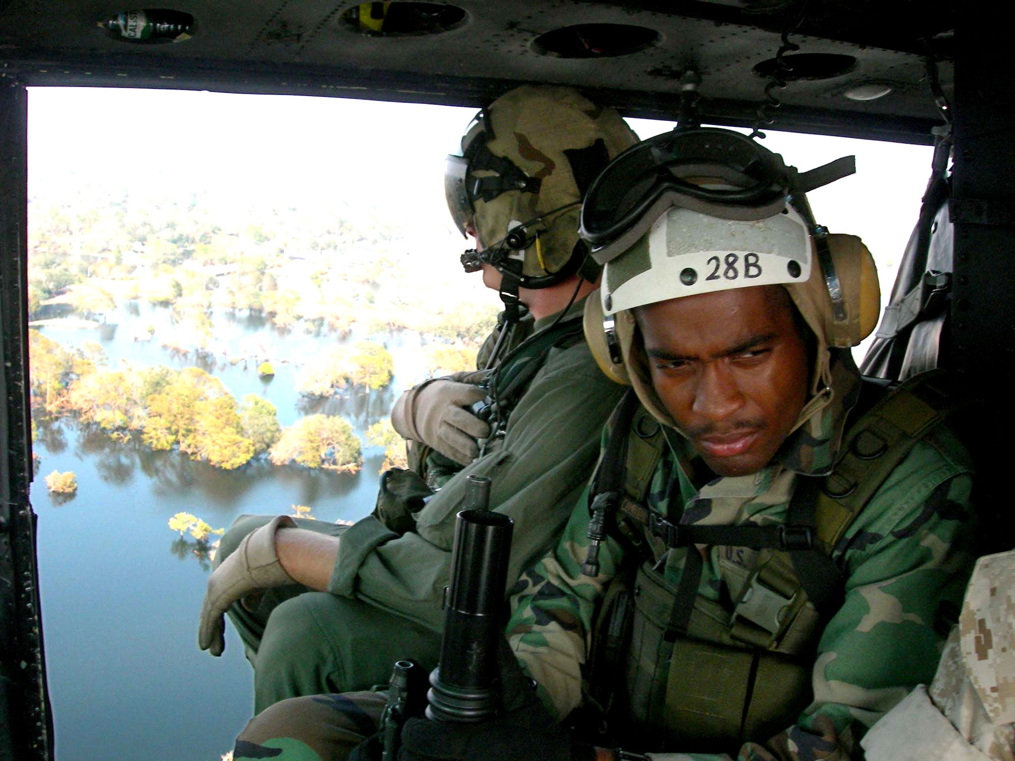 NEW ORLEANS -- Airman 1st Class Brandon Johnson surveys flood-damaged New Orleans, his hometown, while aboard a Navy helicopter.  He and other Airmen with the 822nd Security Forces Squadron from Moody Air Force Base, Ga., were providing security for news media aboard.  (U.S. Air Force photo by 1st Lt. Nathan D. Broshear)
