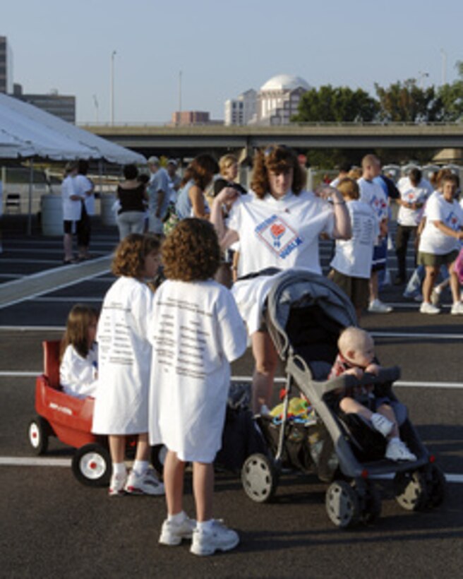 People of all ages prepare for the America Supports You Freedom Walk at the Pentagon in Arlington, Va., on Sept. 11, 2005. The walk was held in remembrance of the victims of Sept. 11, 2001, and to honor our servicemen and women working to preserve freedom around the world. The walk began near the Pentagon crash site, passed Arlington National Cemetery and proceeded past several National Monuments to conclude on the National Mall by the Reflecting Pool. The participants were invited to attend a musical tribute by country singer and songwriter Clint Black at the end of the walk. 