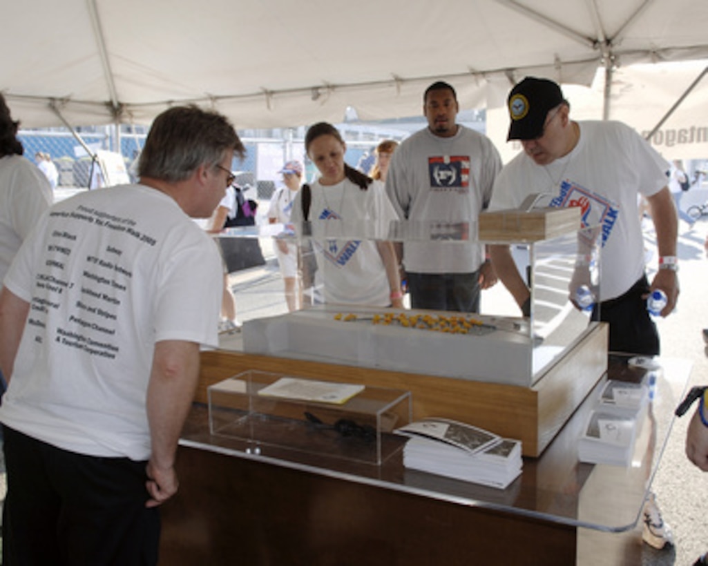 Participants in the America Supports You Freedom Walk view a model of the Pentagon Memorial at the Pentagon in Arlington, Va., on Sept. 11, 2005. The walk was held in remembrance of the victims of Sept. 11, 2001, and to honor our servicemen and women working to preserve freedom around the world. The walk began near the Pentagon crash site, passed Arlington National Cemetery and proceeded past several National Monuments to conclude on the National Mall by the Reflecting Pool. The participants were invited to attend a musical tribute by country singer and songwriter Clint Black at the end of the walk. The memorial will be built at the site of the terrorist attack at the Pentagon. 