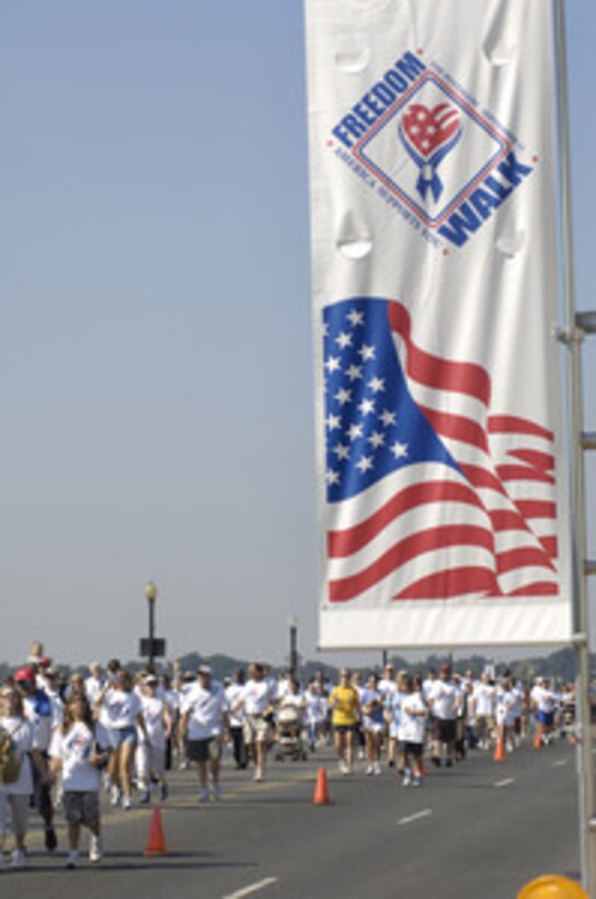 Thousands of people cross the Potomac River on the Memorial Bridge during the America Supports You Freedom Walk in Washington, D.C., on Sept. 11, 2005. The walk was held in remembrance of the victims of Sept. 11, 2001, and to honor our servicemen and women working to preserve freedom around the world. The walk began near the Pentagon crash site, past Arlington National Cemetery and proceeded past several National Monuments to conclude on the National Mall by the Reflecting Pool. The participants were invited to attend a musical tribute by country singer and songwriter Clint Black at the end of the walk. 