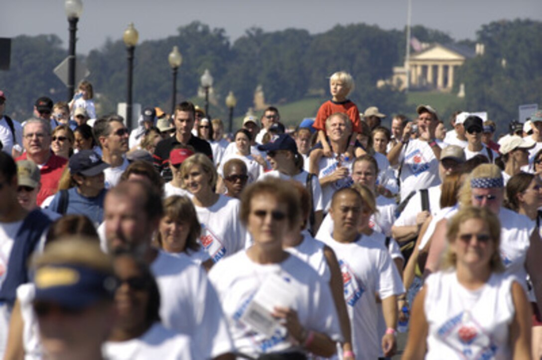 Thousands of people cross the Potomac River on the Memorial Bridge during the America Supports You Freedom Walk in Washington, D.C., on Sept. 11, 2005. The walk was held in remembrance of the victims of Sept. 11, 2001, and to honor our servicemen and women working to preserve freedom around the world. The walk began near the Pentagon crash site, past Arlington National Cemetery and proceeded past several National Monuments to conclude on the National Mall by the Reflecting Pool. The participants were invited to attend a musical tribute by country singer and songwriter Clint Black at the end of the walk. 