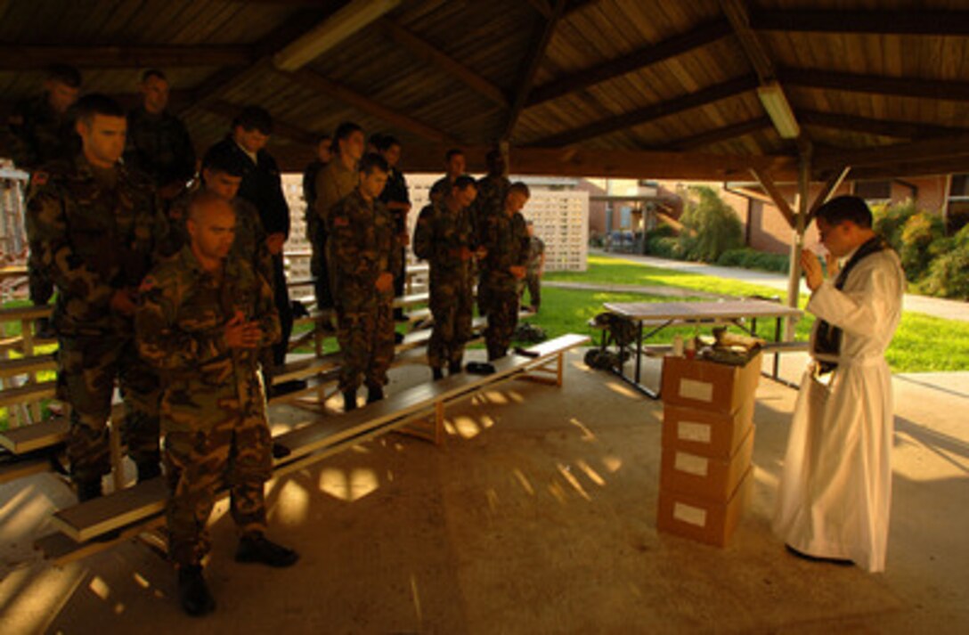 Air Force Chaplain Hayden Vavarek conducts a Catholic Mass for joint service members at Naval Air Station New Orleans, La., on Sept. 11, 2005. Department of Defense units are mobilized as part of Joint Task Force Katrina to support the Federal Emergency Management Agency's disaster relief efforts in the Gulf Coast areas devastated by Hurricane Katrina. Maj. Vavarek is assigned to the 315th Airlift Wing, Charleston Air Force Base, S.C. 