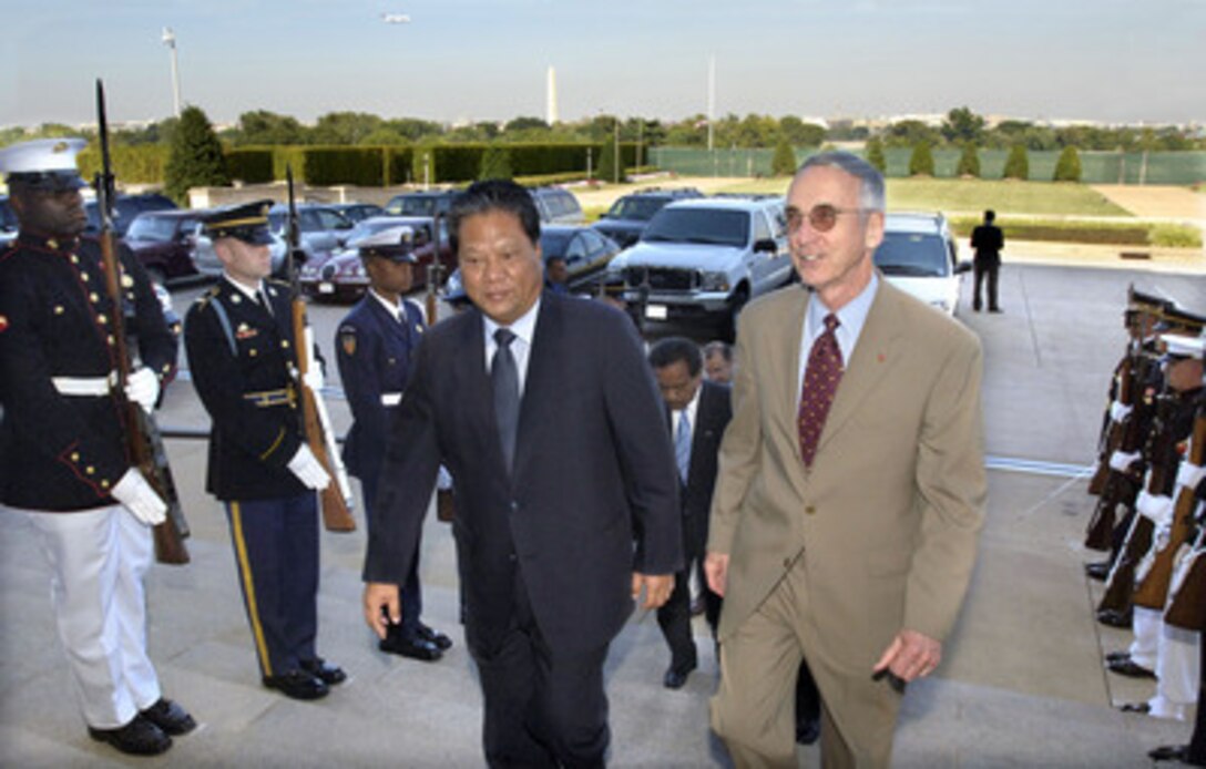 Acting Deputy Secretary of Defense Gordon England (right) escorts President of the Republic of the Marshall Islands Kessai Note through an honor cordon and into the Pentagon on Sept. 12, 2003. England and Note will meet to discuss a broad range of regional issues. 