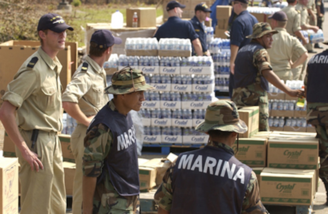 U.S. Navy, Royal Dutch, and Mexican sailors work alongside American Red Cross personnel to hand out water, food and relief supplies on Sept. 12, 2005, to residents in Biloxi, Miss. The Dutch and Mexican personnel have joined the Department of Defense units mobilized as part of Joint Task Force Katrina to support the Federal Emergency Management Agency's disaster relief efforts in the Gulf Coast areas devastated by Hurricane Katrina. 