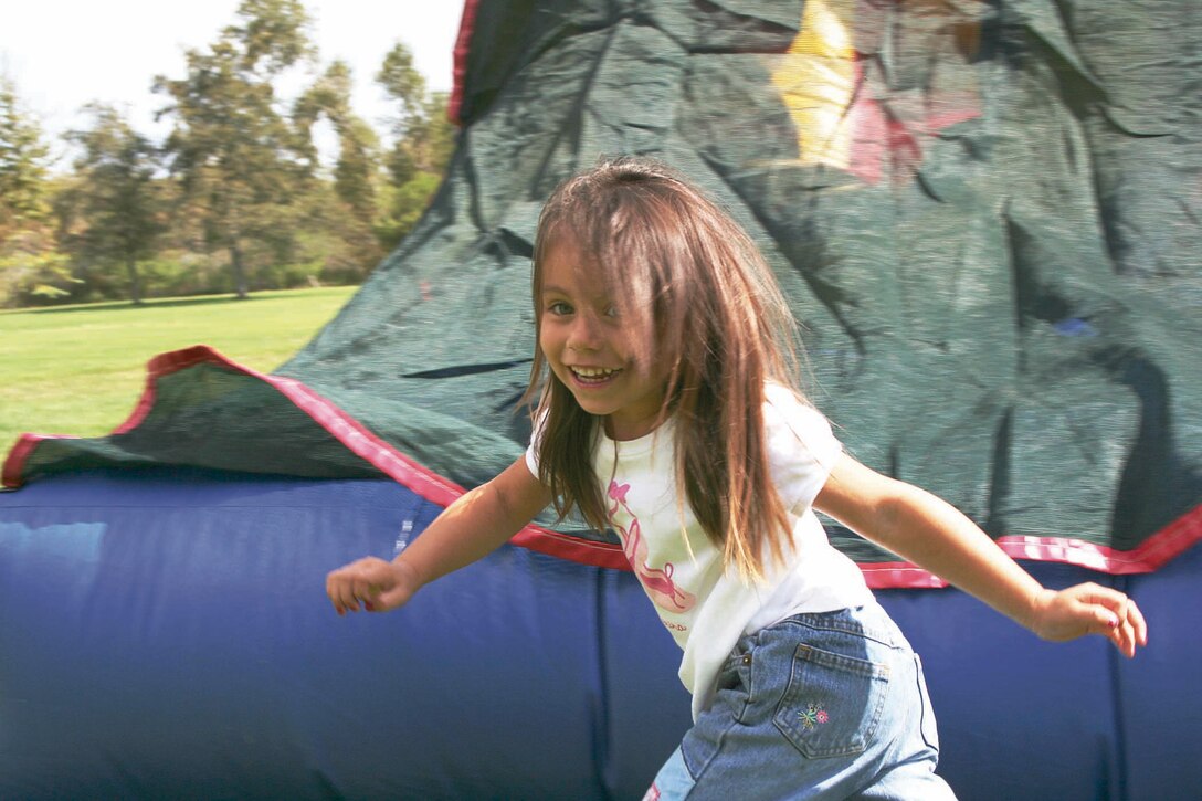 Children ran and jumped through a bounce house on the lawn of the Ranch House on Camp Pendleton, Calif., Sept. 14. Emily J. Gonzalez was full of energy as she ran back for another romp through the house.