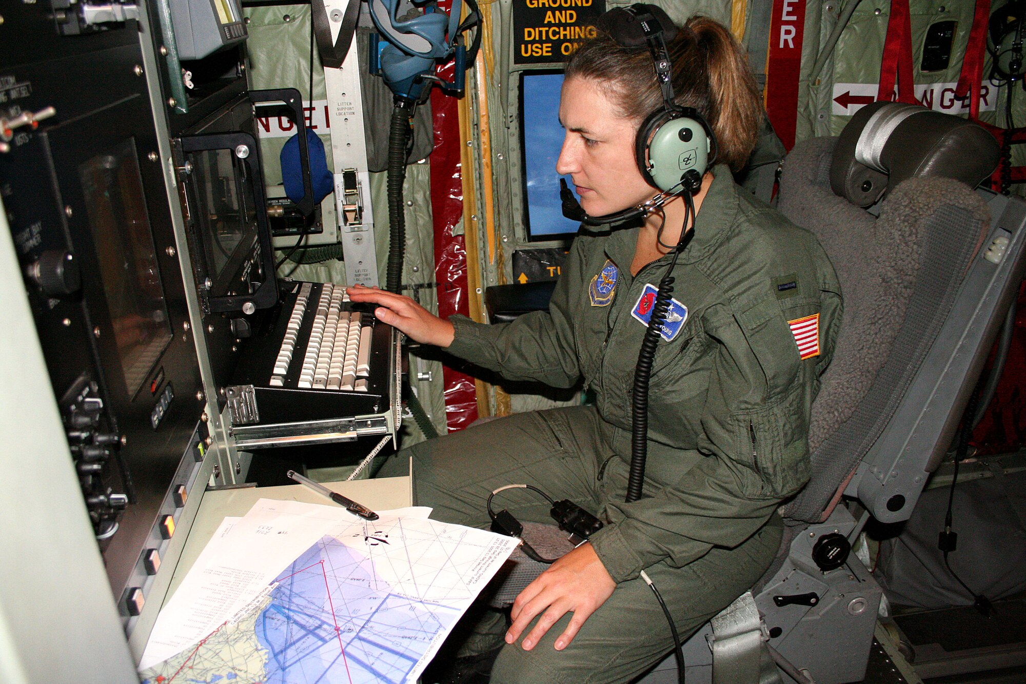OVER THE ATLANTIC OCEAN -- First Lt. Tina Young examines data gathered while flying into the eye of Hurricane Ophelia on Sept. 14. As a member of the Hurrican Hunters, the lieutenant relayed weather information directly to the National Hurricane Center to help people along the east coast prepare for the approaching storm. Lieutenant Young is an aerial reconnaissance weather officer with the 53rd Weather Reconnaissance Squadron that has temporarily relocated from Keesler Air Force, Miss., to Dobbins Air Reserve Base, Ga. (U.S. Air Force photo by Staff Sgt. Michael Eaton)