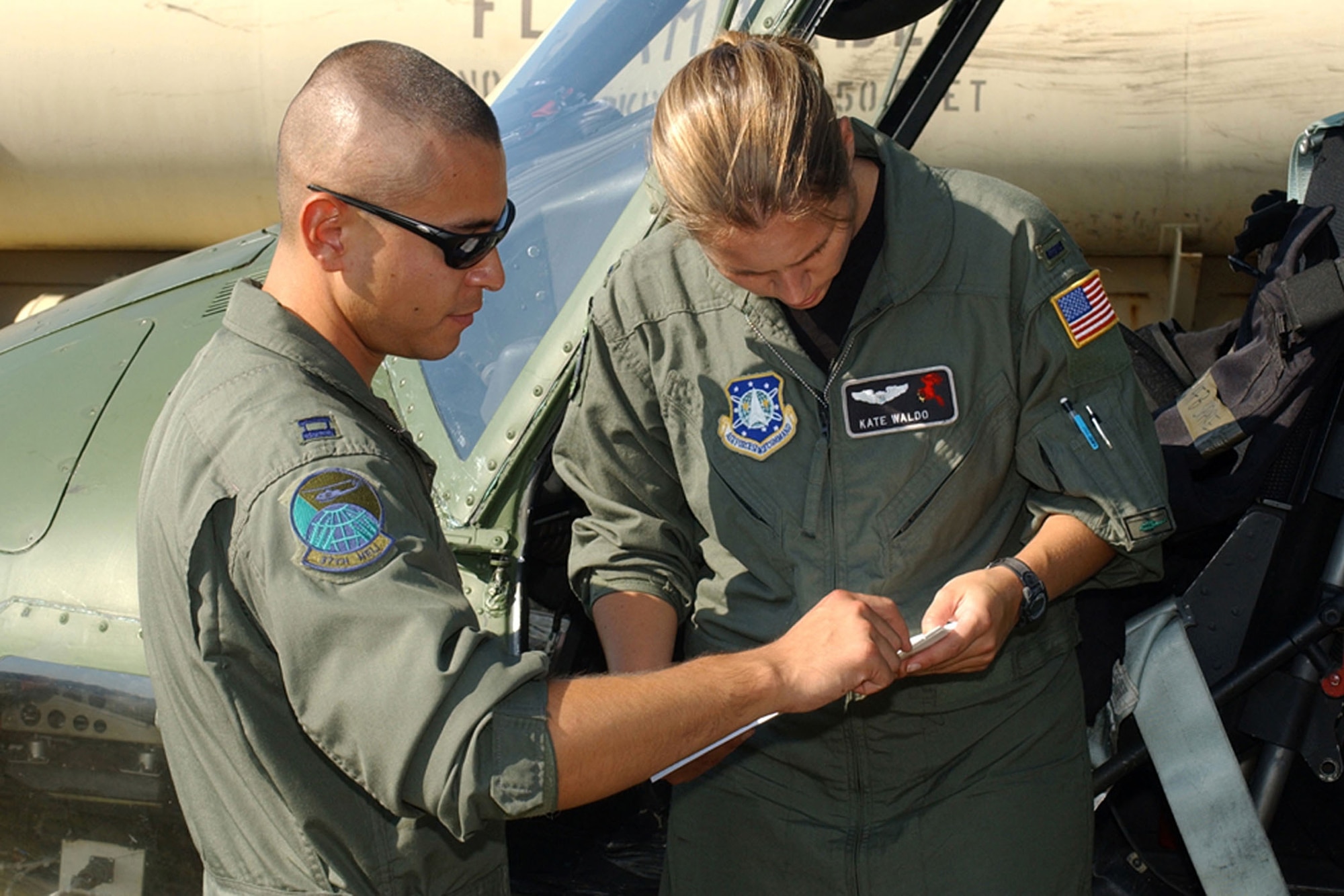 COLUMBUS AIR FORCE BASE, Miss. -- Capt. Jake Brittingham (left) and 1st Lt. Kate Waldo prepare for take off to deliver supplies in the Gulf Coast area of Mississippi to those who have been affected by Hurricane Katrina.  Both are pilots with the 620th Air Expeditionary Squadron here.  Captain Brittingham is deployed from F.E. Warren Air Force Base, Wyo., and Lieutenant Waldo is deployed from Vandenberg AFB, Calif.  (U.S. Air Force photo by Senior Airman John Parie)
