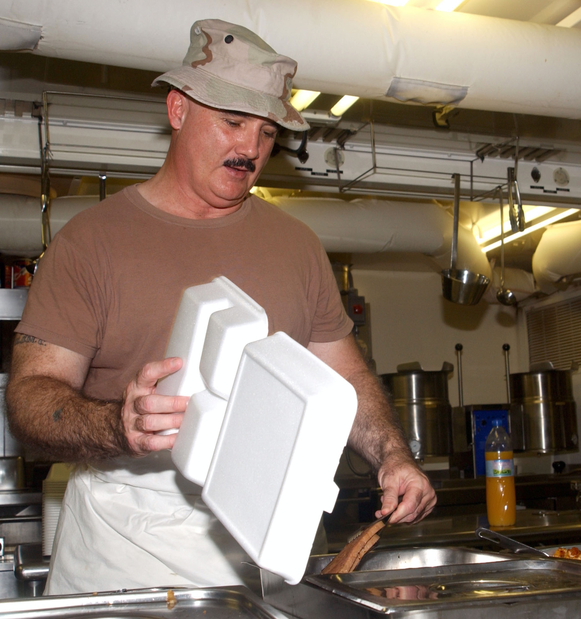 SOUTHWEST ASIA -- Staff Sgt. James Murphy serves food at the flightline dining facility here.  His military career spans 30 years and he has been in the Marines, Army National Guard, Navy and Air Force Reserve. Sergeant Murphy is assigned to the 380th Expeditionary Services Squadron. (U. S. Air Force photo by Master Sgt. Cheryl L. Toner)
