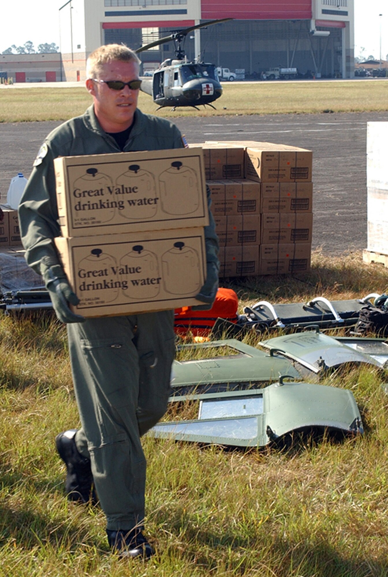 COLUMBUS AIR FORCE BASE, Miss. - Tech. Sgt. Chad Hagan loads supplies onto a waiting helicopter here.  Squadron members have been delivering food and water daily to those who have been affected by Hurricane Katrina.  Sergeant Hagan is a 620th Air Expeditionary Squadron flight engineer.  (U.S. Air Force photo by Senior Airman John Parie)