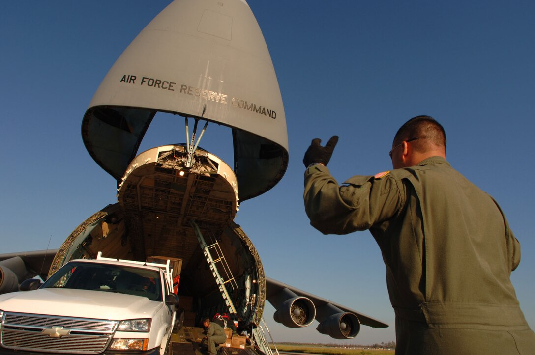 LOUIS ARMSTRONG NEW ORLEANS INTERNATIONAL AIRPORT, La.  -- Tech. Sgt. Arthur Reyes offloads support equipment for fire and rescue personnel from a C-5 Galaxy here Sept. 8.  Department of Defense units have mobilized as part of Joint Task Force-Katrina to support the Federal Emergency Management Agency's disaster relief efforts on the Gulf Coast. Sergeant Reyes is assigned to the 68th Airlift Squadron at Lackland Air Force Base, Texas (U.S. Air Force photo by Staff Sgt. Jacob N. Bailey) 