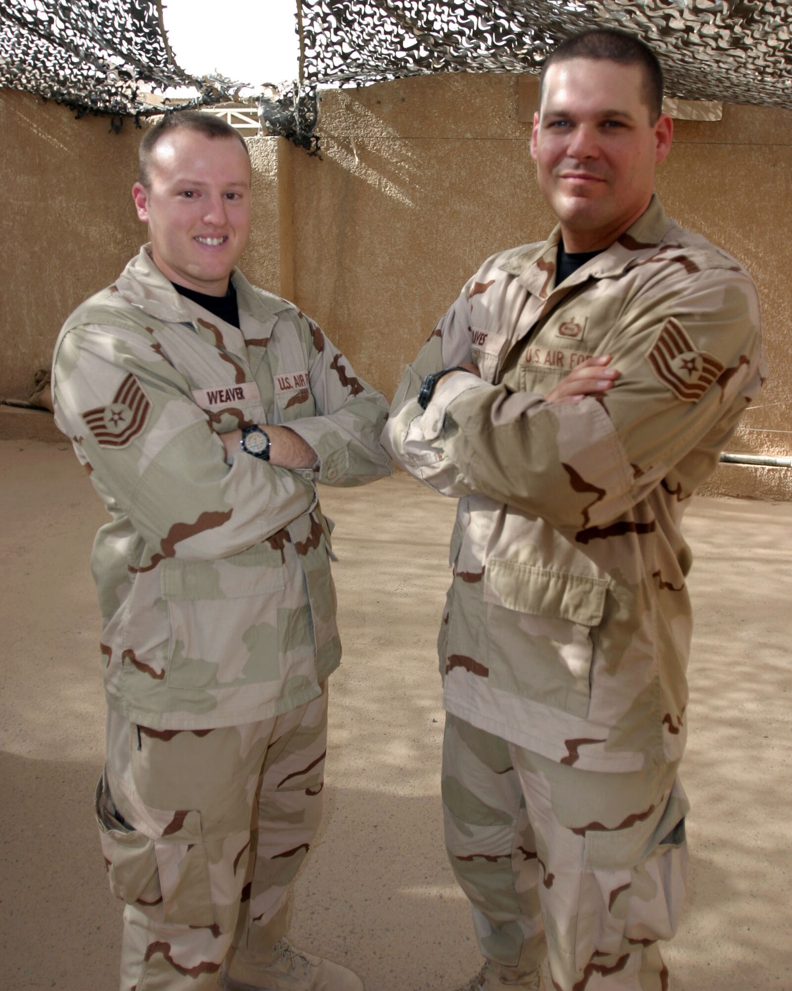 IRAQ -- Tech. Sgts. Carl Weaver (left) and Jason Graves are deployed supporting the Marine Multinational Force-West's command operations center.  They are the first enlisted Airmen to be assigned to the center.  They are from Barksdale Air Force Base, La.  (U.S. Air Force photo)