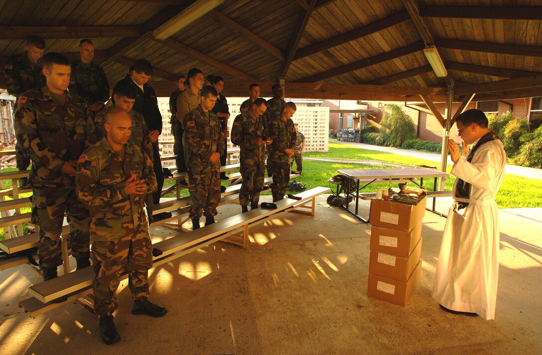 NAVAL AIR STATION NEW ORLEANS, La. -- Air Force Chaplain (Major) Hayden Vavarek conducts service for joint servicemembers here Sept. 11.  Department of Defense units are mobilized as part of Joint Task Force-Katrina to support the Federal Emergency Management Agency's disaster relief efforts in the Gulf Coast areas devastated by Hurricane Katrina.  Chaplain Vavarek is assigned to the 315th Airlift Wing at Charleston Air Force Base, S.C.  (U.S. Air Force photo by Staff Sgt. Jacob N. Bailey)