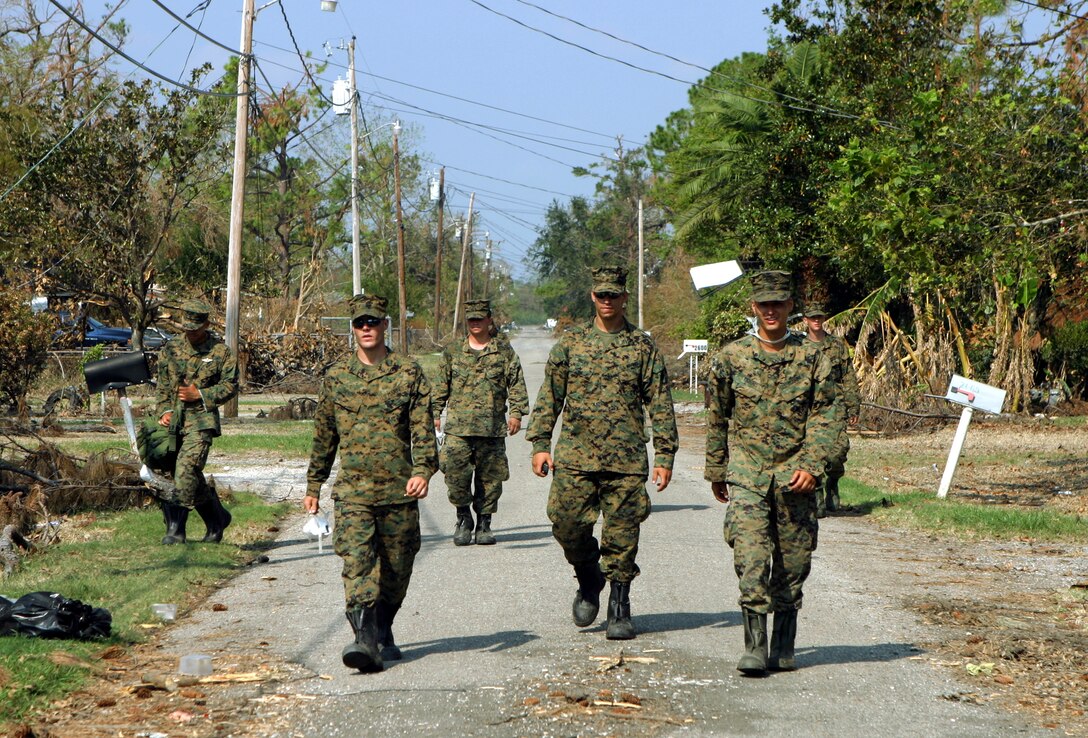 Violet, La. (Sept. 15, 2005) - Marines from 3rd Platoon, Charlie Company, 1st Battalion, 8th Marines, walk the streets of Violet, La., a community in St. Bernard Parish. Charlie Co., has been conducting aid-and-recovery missions in the parish since its arrival from Slidell, La., Sept. 10.