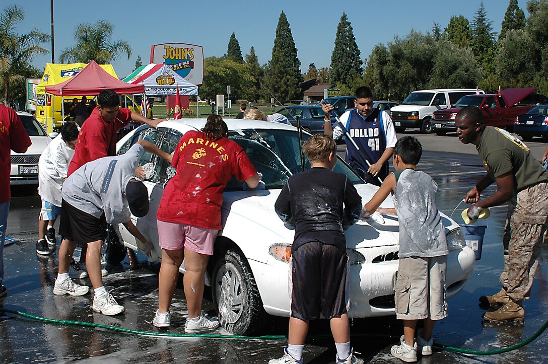 SSgt. Gerald J. Walton, recruiter, Recruiting Sub-station Stockton, along with poolees, Young Marines and their familiy members get their hands wet for a good cause.