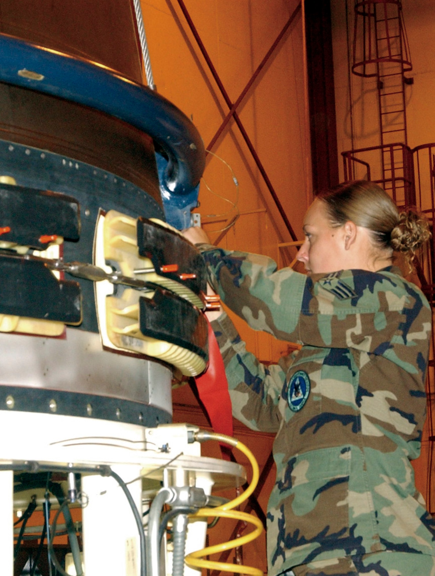 F.E. WARREN AIR FORCE BASE, Wyo. -- Senior Airman Sarah Holznagel works on a Peacekeeper missile.  The last Peacekeeper will be deactivated Sept 19.  She is a maintainer with the 90th Missile Maintenance Squadron here.  (U.S. Air Force photo by 2nd Lt. Josh Edwards)