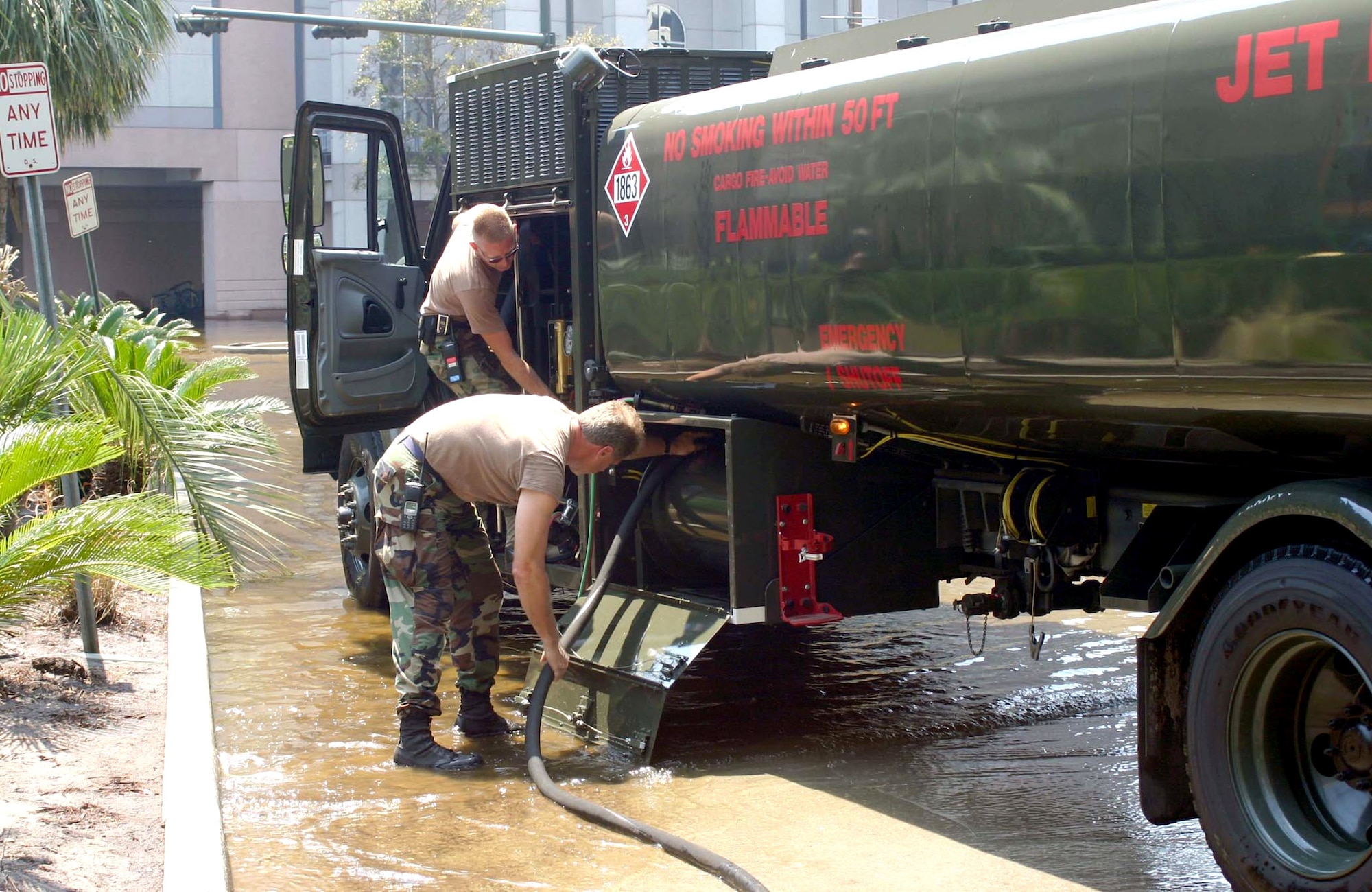 NEW ORLEANS -- Staff Sgt. Tim Childress (back) helps Master Sgt. Steve Wilgus prepare an R-11 jet fuel truck for a mission here.  A fuels team from Barksdale Air Force Base, La., deployed here to assist with refueling operations in the city, to include refueling generators and stranded vehicles.  Sergeant Childress is assigned to the 2nd Logistics Readiness Squadron at Barksdale, and Sergeant Wilgus is with the Louisiana Air National Guard.  (U.S. Air Force photo)