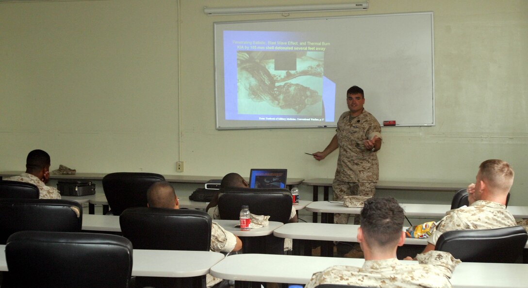 CAMP PENDLETON, Calif. (Sept. 16, 2005) - Navy Petty Officer 1st Class Jesse G. Arzate, a hospital corpsman with the 15th Marine Expeditionary Unit, shows a class of Marines the effects a 105-mm artillery round detonation has on a human body. Arzate taught more than 30 Marines about combat injuries, Sexually Transmitted Diseases, and field sanitation during scheduled medical class.
