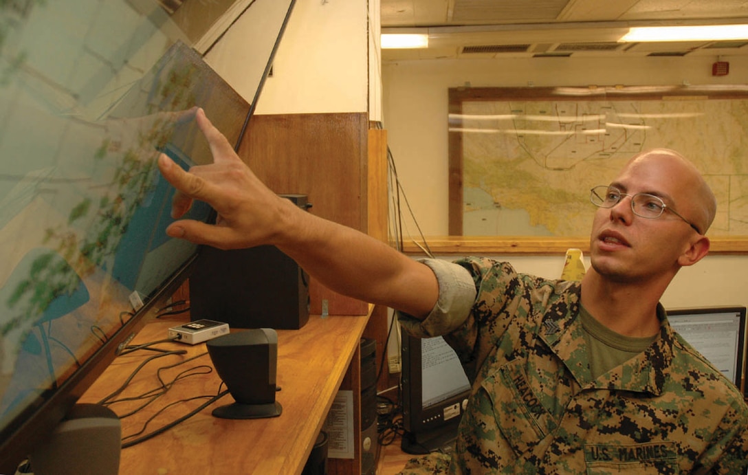 Sgt. Michael A. Heacock, Headquarters and Headquarters Squadron weather forecaster and native of Tujunga, Calif., tracks clouds on the Station Meteorological Oceanographic Command?s ?wall of thunder? Sept. 23. The Marines at METOC are split into two different military occupational specialties ? observers, who gather data about the current weather conditions; and forecasters, who use that data to predict what changes might happen anywhere from the next hour to 24 hours.