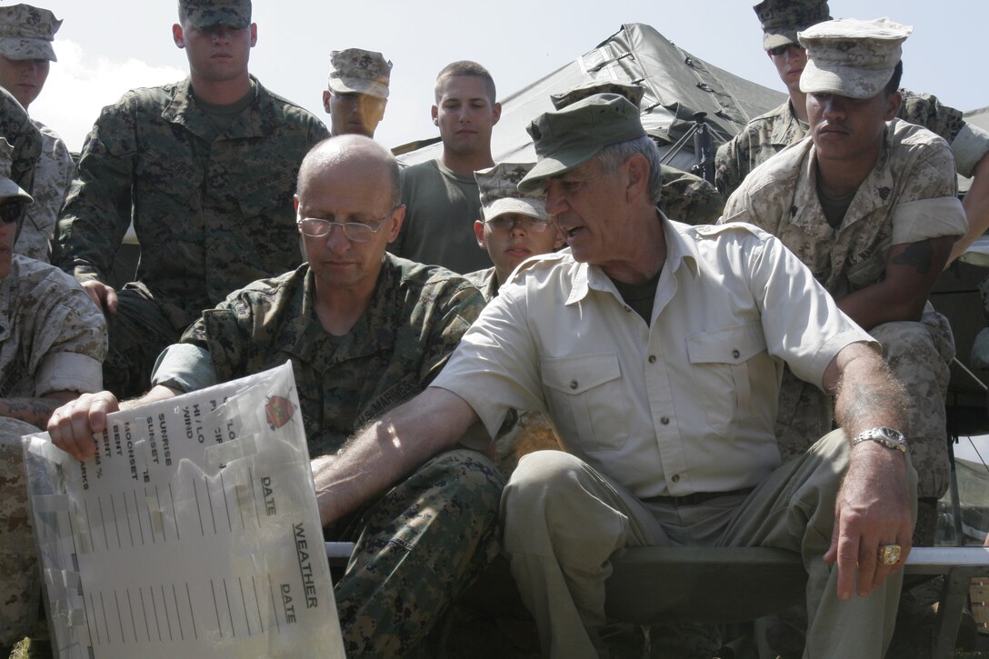 Retired Gunnery Sgt. R. Lee Ermy receives an operations brief from Master Sgt. Donald L. Funkhouser, operations chief, 1st Battalion, 8th Marines, 2nd Marine Division. Ermy visited the Marines in the course of the leathernecks' efforts in rebuilding the New Orleans area after the devastation wrought upon it by Hurricane Katrina.