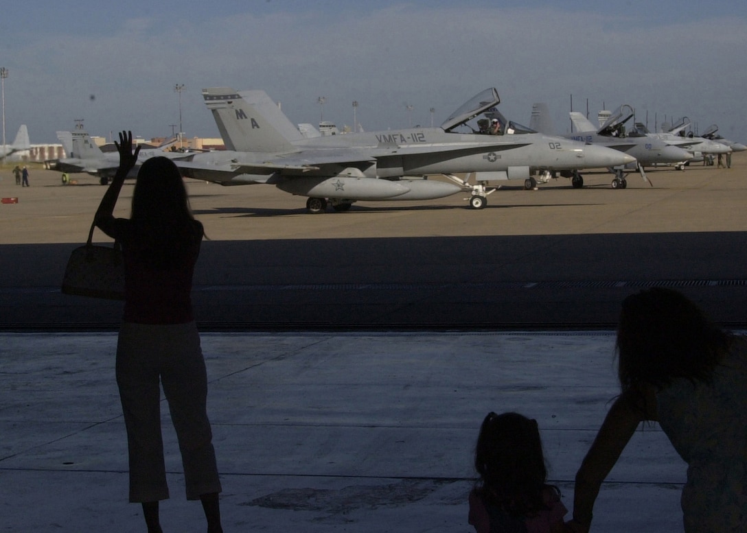 Lt. Col. Bill "Rock" Collins, commanding officer, Marine Fighter Attack Squadron 112, waves to his family as he taxies to the runway of Naval Air Station-Joint Reserve Base Fort Worth, Texas on Sept. 18, 2005.  Collins will spend the next few weeks in England taking part in Exercise Urgent Quest.