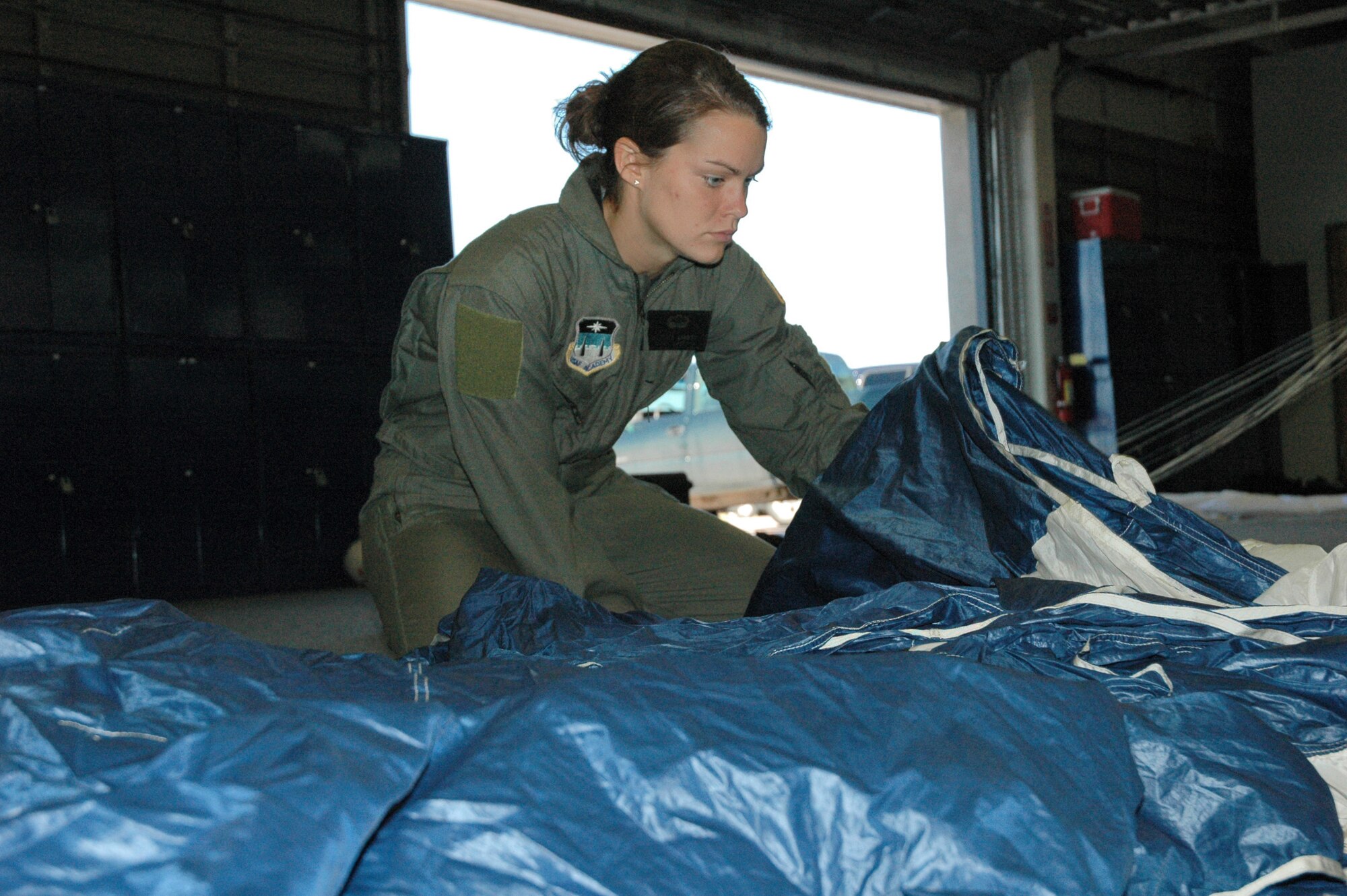 U.S. AIR FORCE ACADEMY, Colo. -- Cadet 3rd Class Kaitlin Tar Dieu flanks the nose of her parachute and checks for control capability.  She is with the "Wings of Green" parachute team, which comprises cadets hopeful to make the academy's "Wings of Blue" parachute demonstration team.  (U.S. Air Force photo by Tech. Sgt. Matt Gilreath)