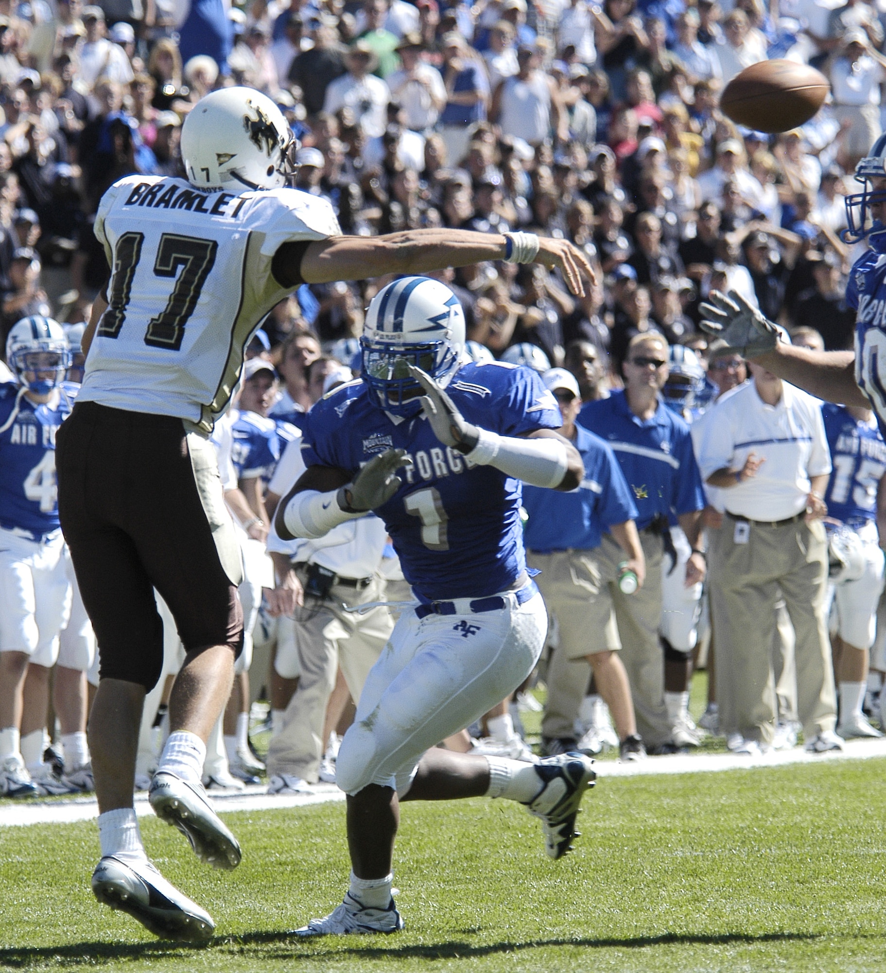 U.S. AIR FORCE ACADEMY, Colo. -- Air Force linebacker Overton Spence puts pressure on University of Wyoming quarterback Corey Bramlett, forcing the Cowboy signal caller to unload early here Sept. 17.  The Cowboys went on to edge the Falcons 29-28.  (U.S. Air Force photo by 2nd Lt. John Ross)