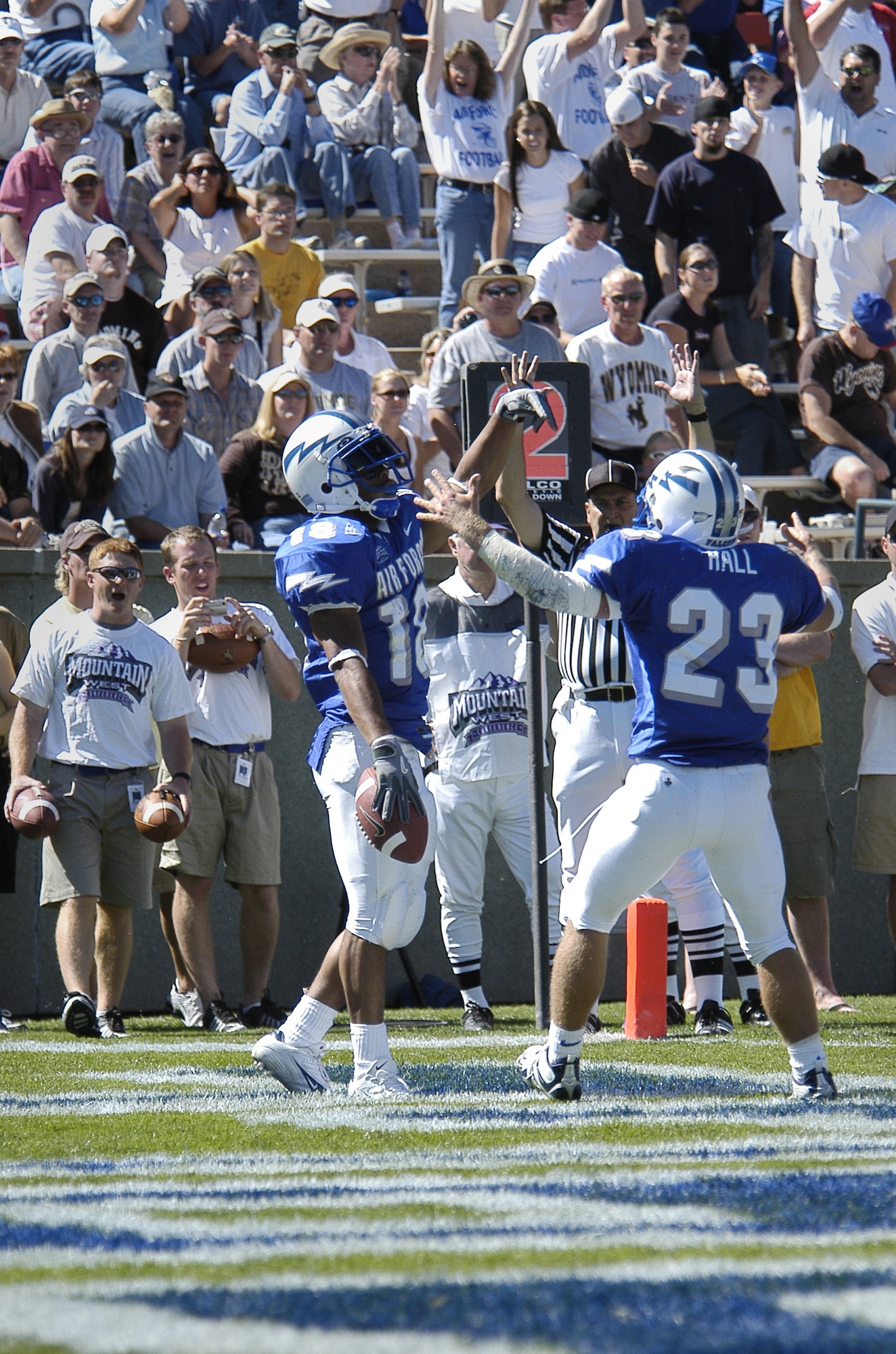 U.S. AIR FORCE ACADEMY, Colo. -- Air Force halfback Chad Hall, 23, helps fellow running back Justin Handley celebrate his first career Falcon touchdown here Sept. 17 against the University of Wyoming.  Hall later scored his first career Air Force touchdown in the same game.  The Cowboys went on to edge the Falcons 29-28.  (U.S. Air Force photo by 2nd Lt. John Ross)