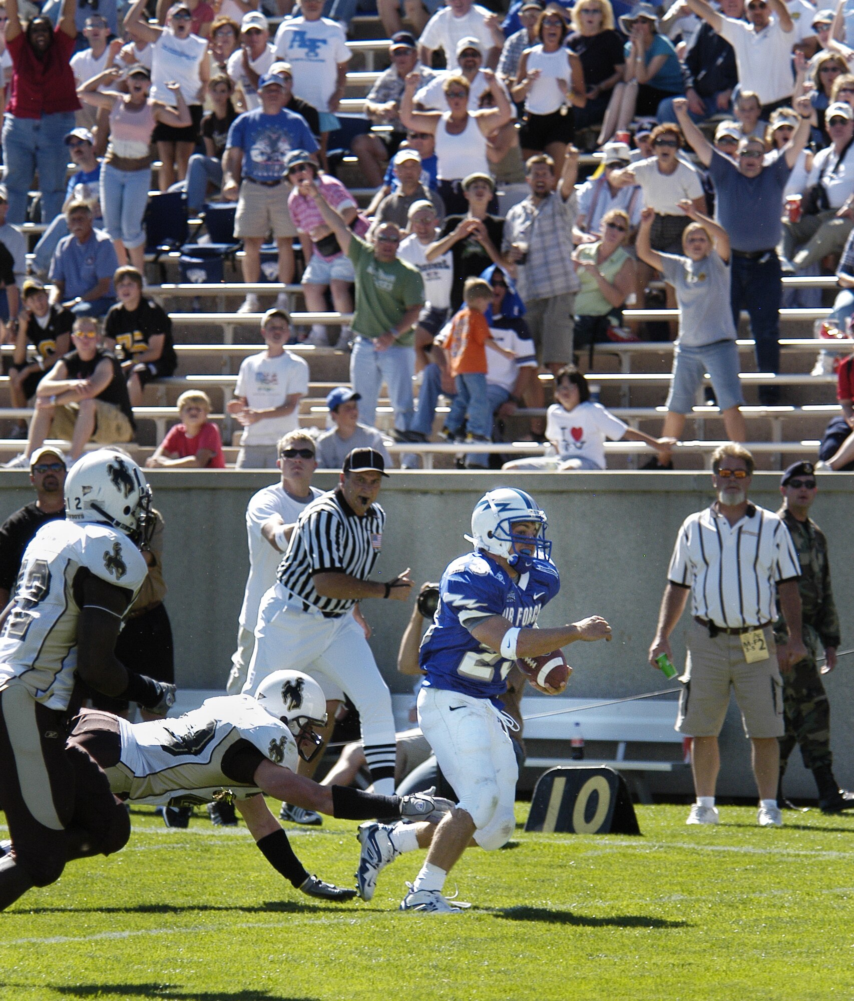 U.S. AIR FORCE ACADEMY, Colo. -- Air Force halfback Chad Hall, 23, eludes a University of Wyoming Cowboy defender on his way to the end zone and his first career Falcon touchdown here Sept. 17.  The Cowboys went on to edge the Falcons 29-28.  (U.S. Air Force photo by 2nd Lt. John Ross)