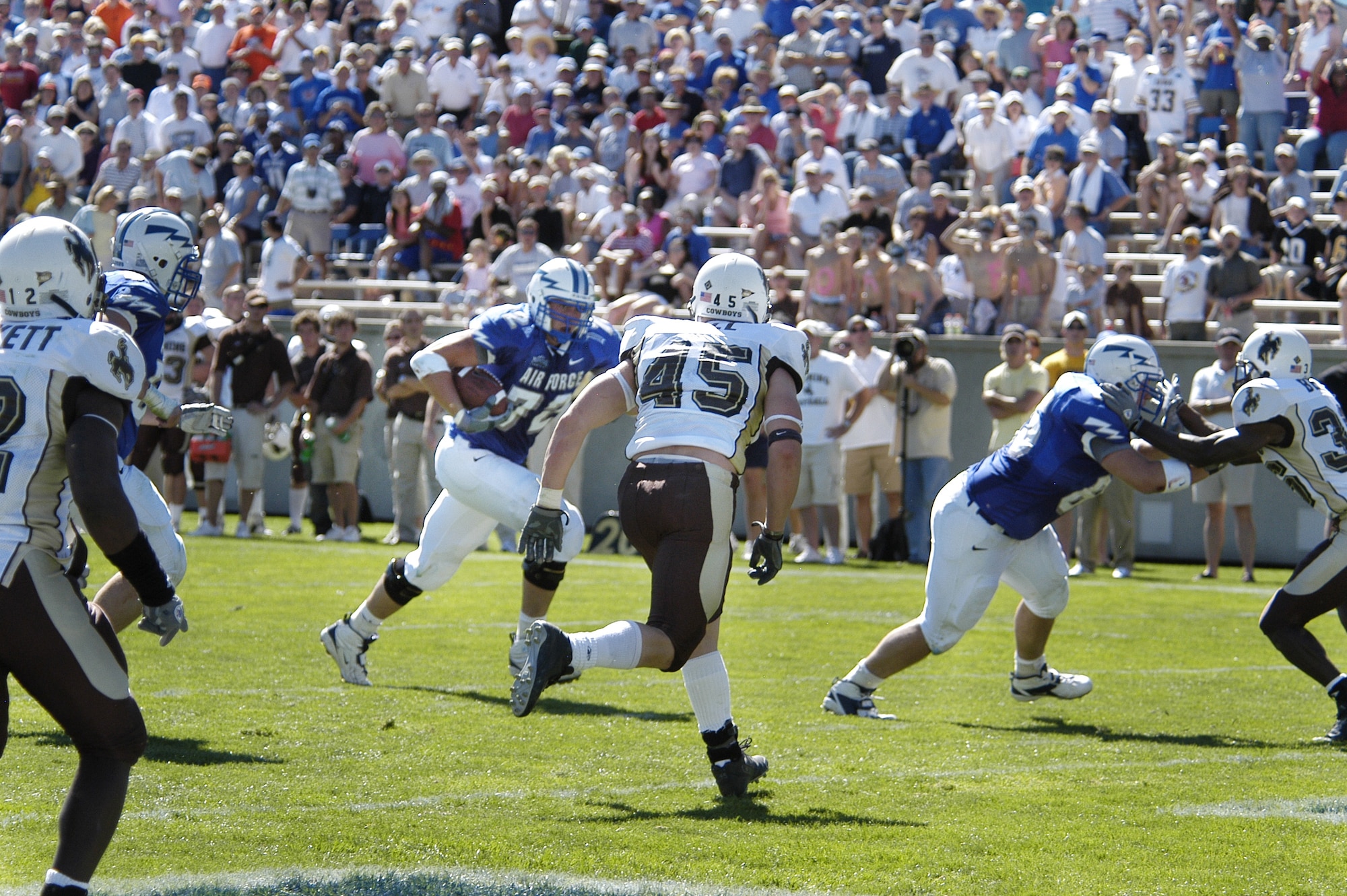U.S. AIR FORCE ACADEMY, Colo. -- Falcon offensive tackle Robert Kraay, 72, eyes University of Wyoming linebacker Austin Hall, 45, on his way to scoring on a two-point conversion following an Air Force touchdown here Sept. 17.  The Cowboys went on to edge the Falcons 29-28.  (U.S. Air Force photo by 2nd Lt. John Ross)