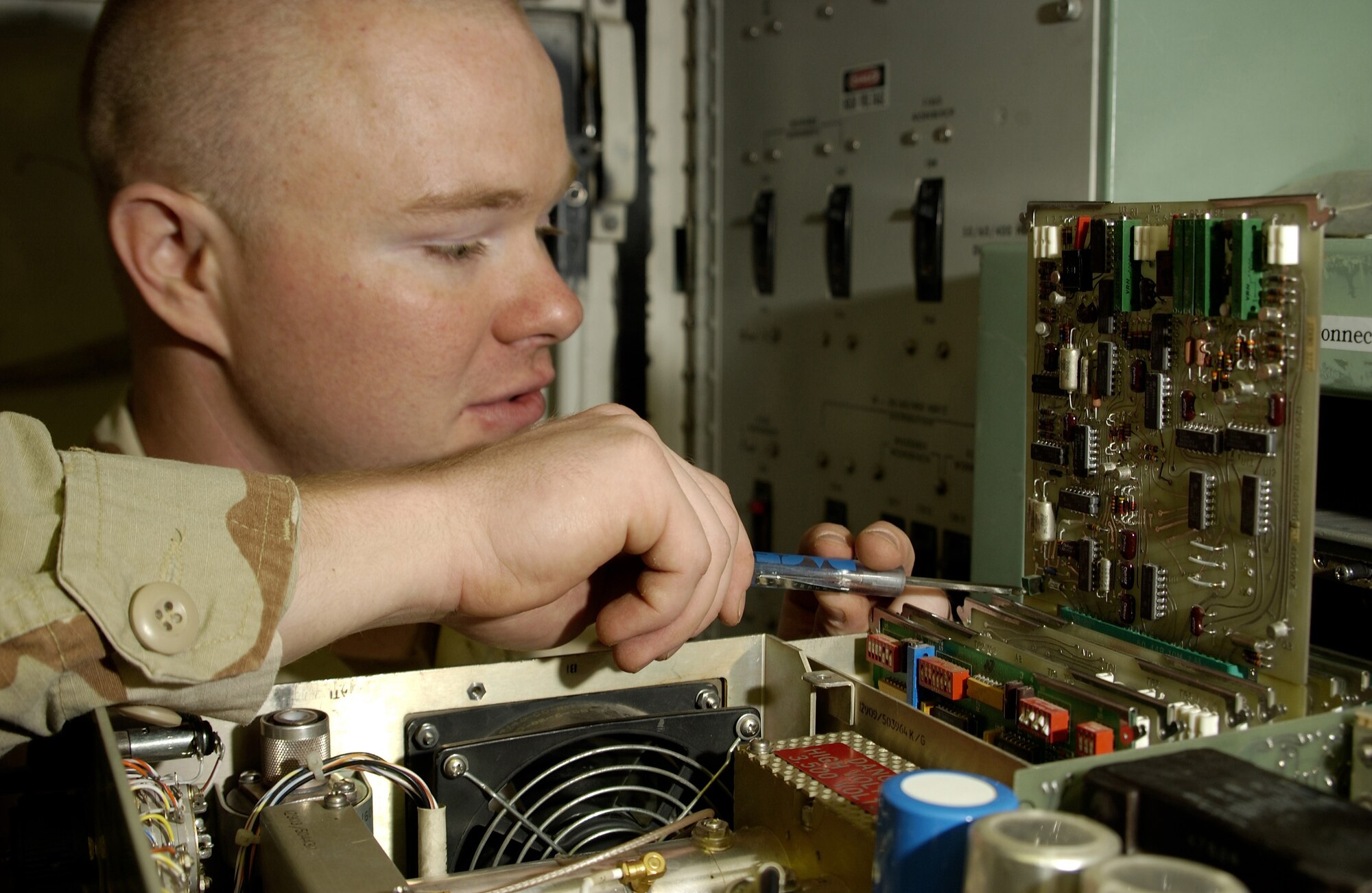 KIRKUK AIR BASE, Iraq -- Airman 1st Class David Reed aligns a UPX-23 Interrogator Set which provides target identification.  He is assigned to the 727th Expeditionary Air Control Squadron Detachment 1 here.  The detachment's Airmen provide commanders and pilots a real-time view of northern Iraq's airspace.  (U.S. Air Force photo by Tech. Sgt. Christopher Gish)