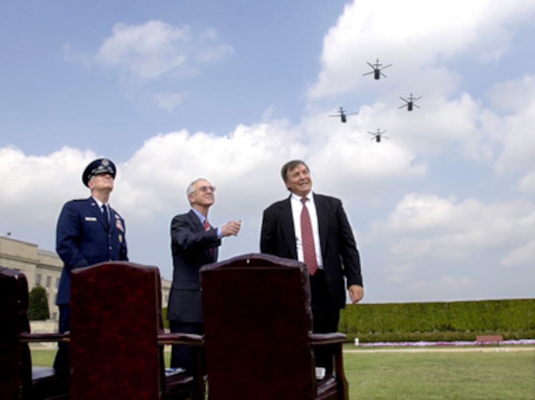 Chairman of the Joint Chiefs of Staff Gen. Richard B. Myers, U.S. Air Force, Acting Deputy Secretary of Defense Gordon England, and Rep. Duncan Hunter of California, chairman of the House Armed Services Committee watch the fly-over of helicopters and jet aircraft in an aerial salute during the National POW/MIA Recognition Day ceremony at the Pentagon on Sept. 16, 2005. The ceremony was attended by many veterans of earlier wars and by representatives of all the nation's veteran service organizations. 