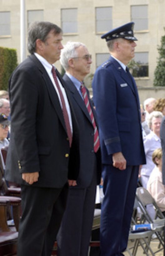 Rep. Duncan Hunter (left) of California, chairman of the House Armed Services Committee, Acting Deputy Secretary of Defense Gordon England (center) and Chairman of the Joint Chiefs of Staff Gen. Richard B. Myers, U.S. Air Force, watch as members of the joint service honor guard pass in review during the National POW/MIA Recognition Day ceremony at the Pentagon on Sept. 16, 2005. The ceremony was attended by many veterans of earlier wars and by representatives of all the nation's veteran service organizations. 