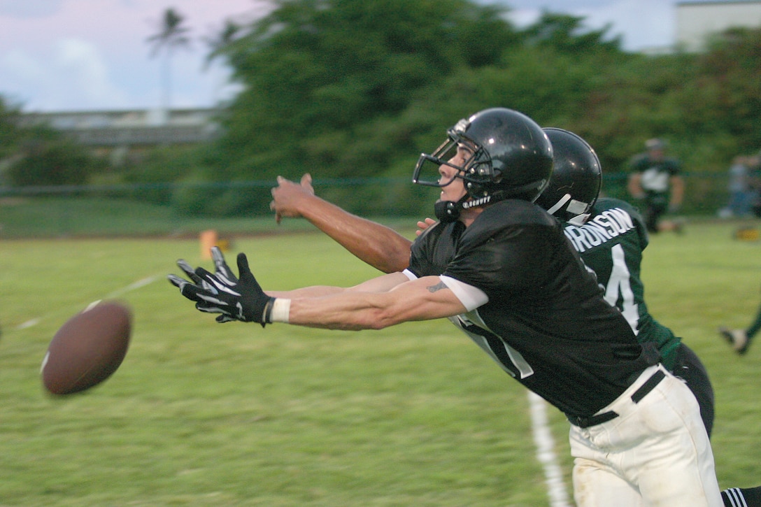 Rick Almeida, wide receiver for the Dirty Three, reaches for what could have been the game-winning touchdown pass Monday night against the 1/12 Bulldogs. After regulation time ended at 6?6, the battle was fought through three overtimes, as Dirty Three quarterback Rafael Perez hooked up repeatedly with Almeida. In the end, though, it was the running game of Bulldog Melvin Hubbert that secured the victory.