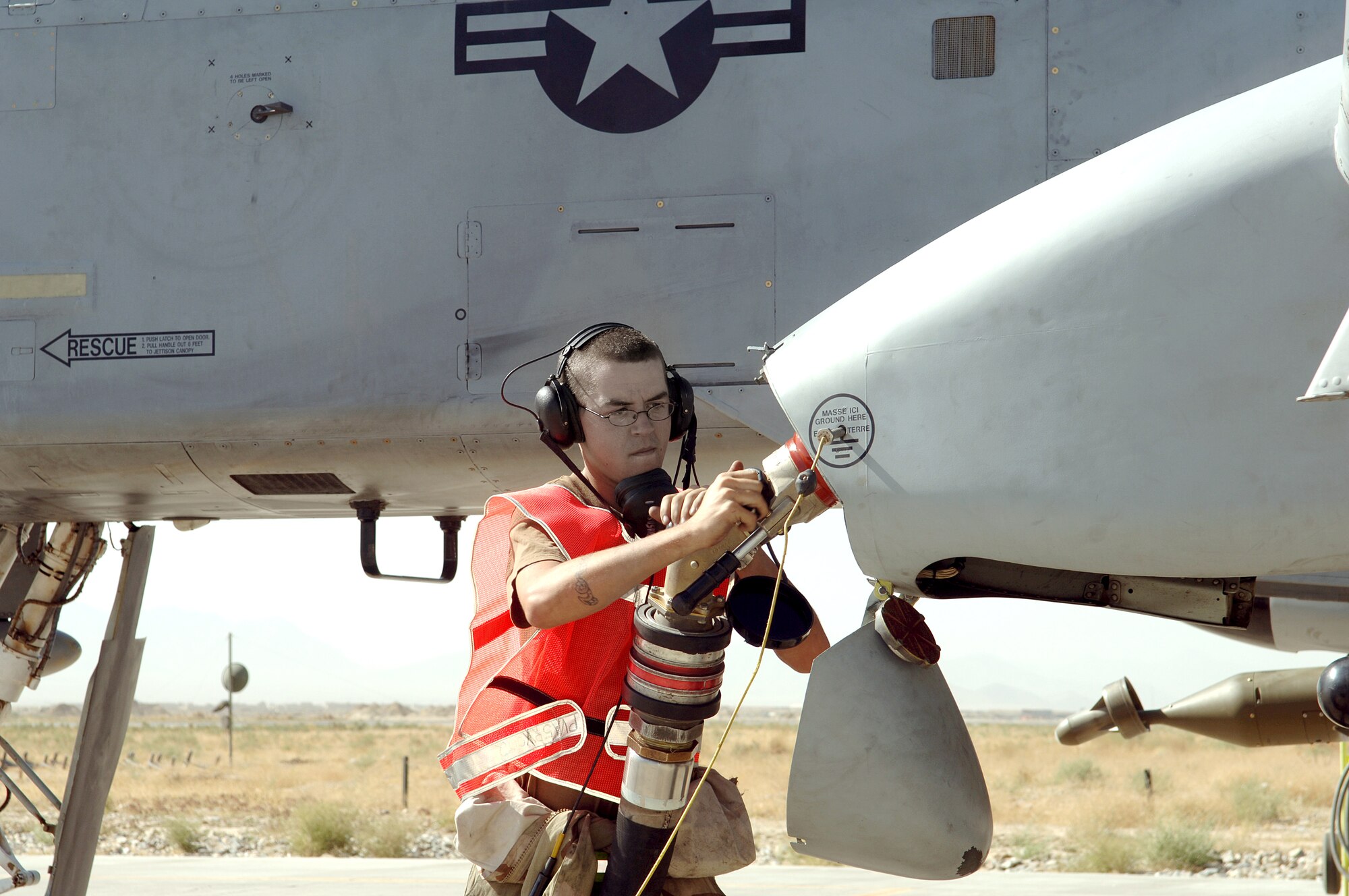 BAGRAM AIR BASE, Afghanistan -- Senior Airman Nathan Albers refuels an A-10 Thunderbolt II here.  The aircraft, along with EC-130H Compass Calls and U.S. Navy EA-6B Prowlers, have stepped up efforts throughout Afghanistan to deter enemy aggression and help ensure voter safety.  Airman Albers is a crew chief deployed from Davis-Monthan Air Force Base, Ariz.  (U.S. Air Force photo by Capt. James H. Cunningham)