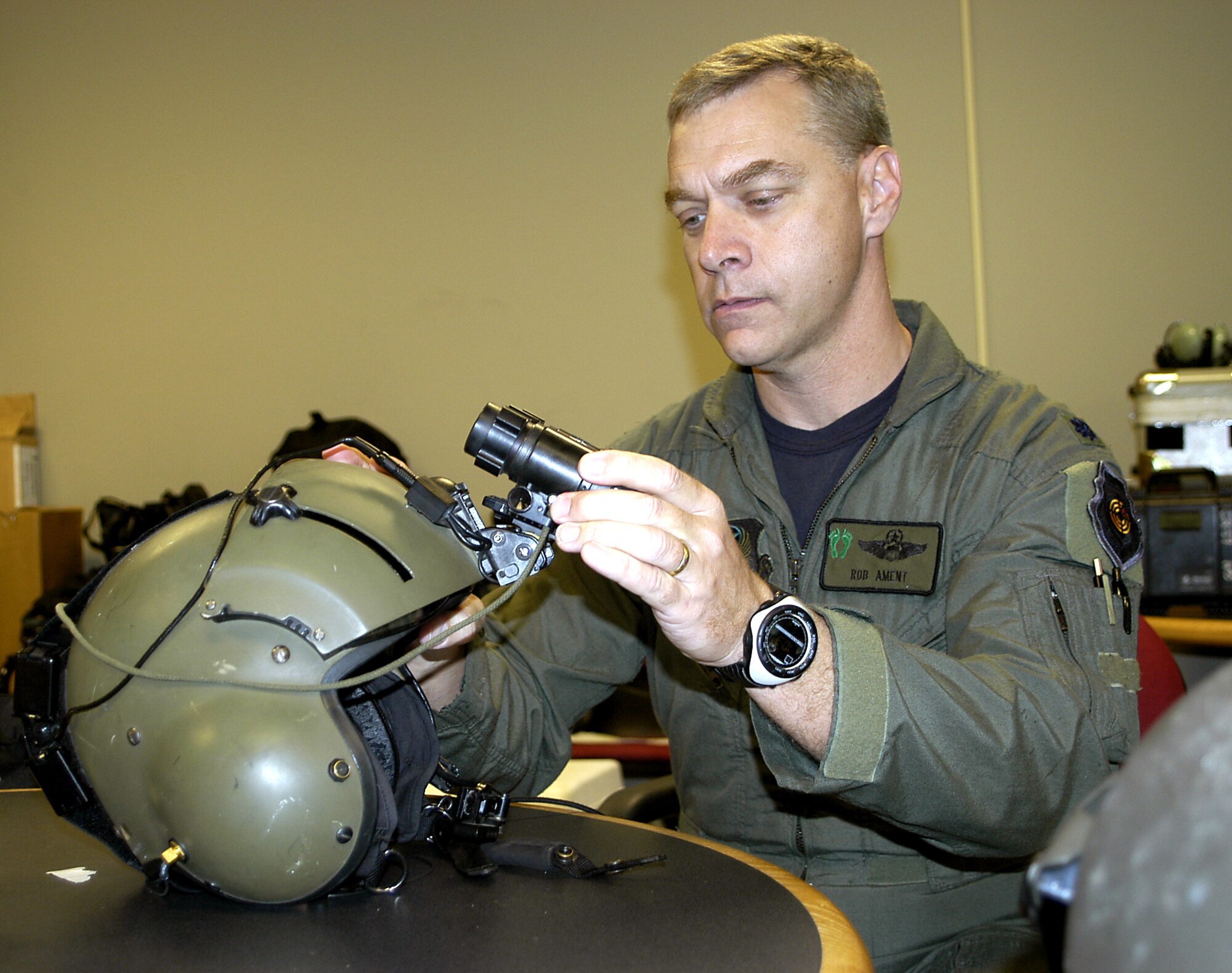 JACKSON, Miss. -- Lt. Col. Rob Ament inspects his night-vision device before a rescue flight.  The devices include night-vision goggles, a helmet mounting system and a battery pack.  Rescuers on HH-60G Pave Hawk helicopters used the equipment to locate people in New Orleans stranded by Hurricane Katrina.  Colonel Ament is the director of operations for Air Force Reserve Command's 920th Rescue Wing at Patrick Air Force Base, Fla.  (U.S. Air Force photo by Senior Master Sgt. Elaine Mayo)