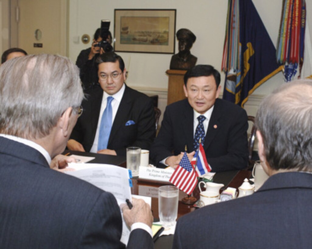 Thailand's Prime Minister Chinnawat Thaksin (right) meets with Secretary of Defense Donald H. Rumsfeld (foreground left) in the Pentagon on Sept. 19, 2005. Thaksin and Rumsfeld are meeting to discuss issues of mutual interest. Prime Minister Thaksin is accompanied by Deputy Prime Minister Sathirathai Surakiart (left). 